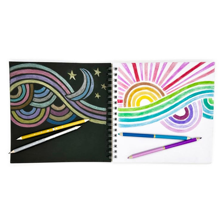 Two spiral-bound notebooks with colorful designs and pens on a white background
