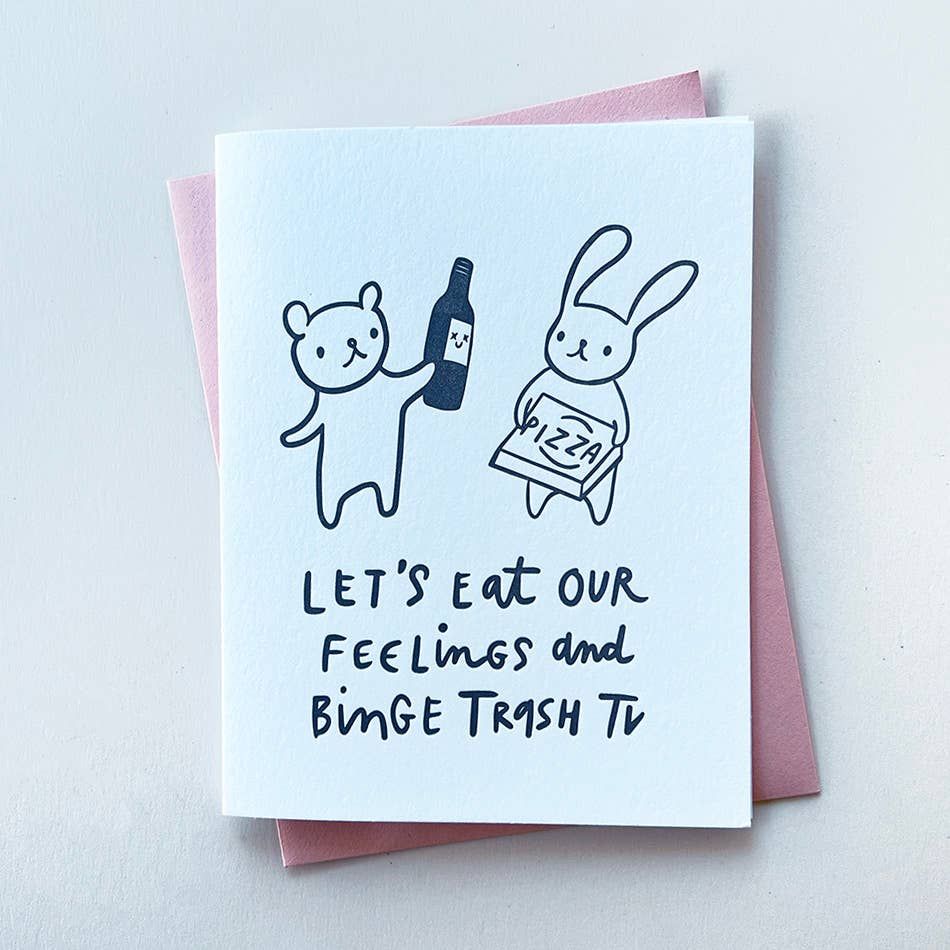 Card with illustrations of a bear and a rabbit holding a bottle and a pizza box, with text 'Let's eat our feelings and binge trash TV' on a light blue background.