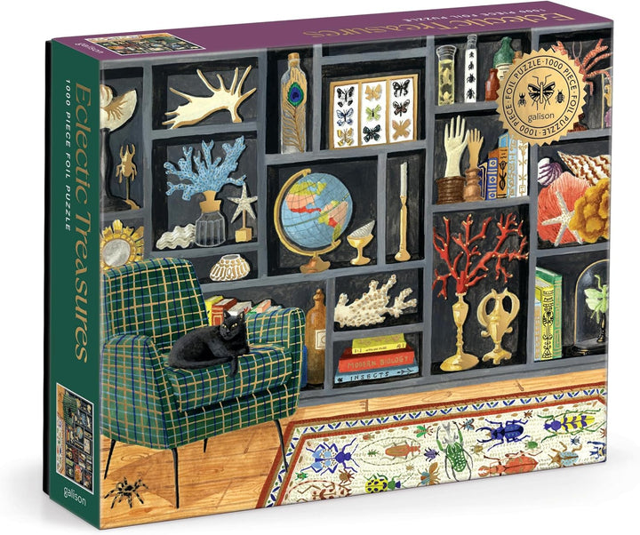 A boxed jigsaw puzzle titled "Bedazzles Treasures" shown at a slight angle. The box art depicts a detailed interior scene with a green plaid armchair, a black cat, shelves filled with decorative objects, books, a globe, and a patterned rug.