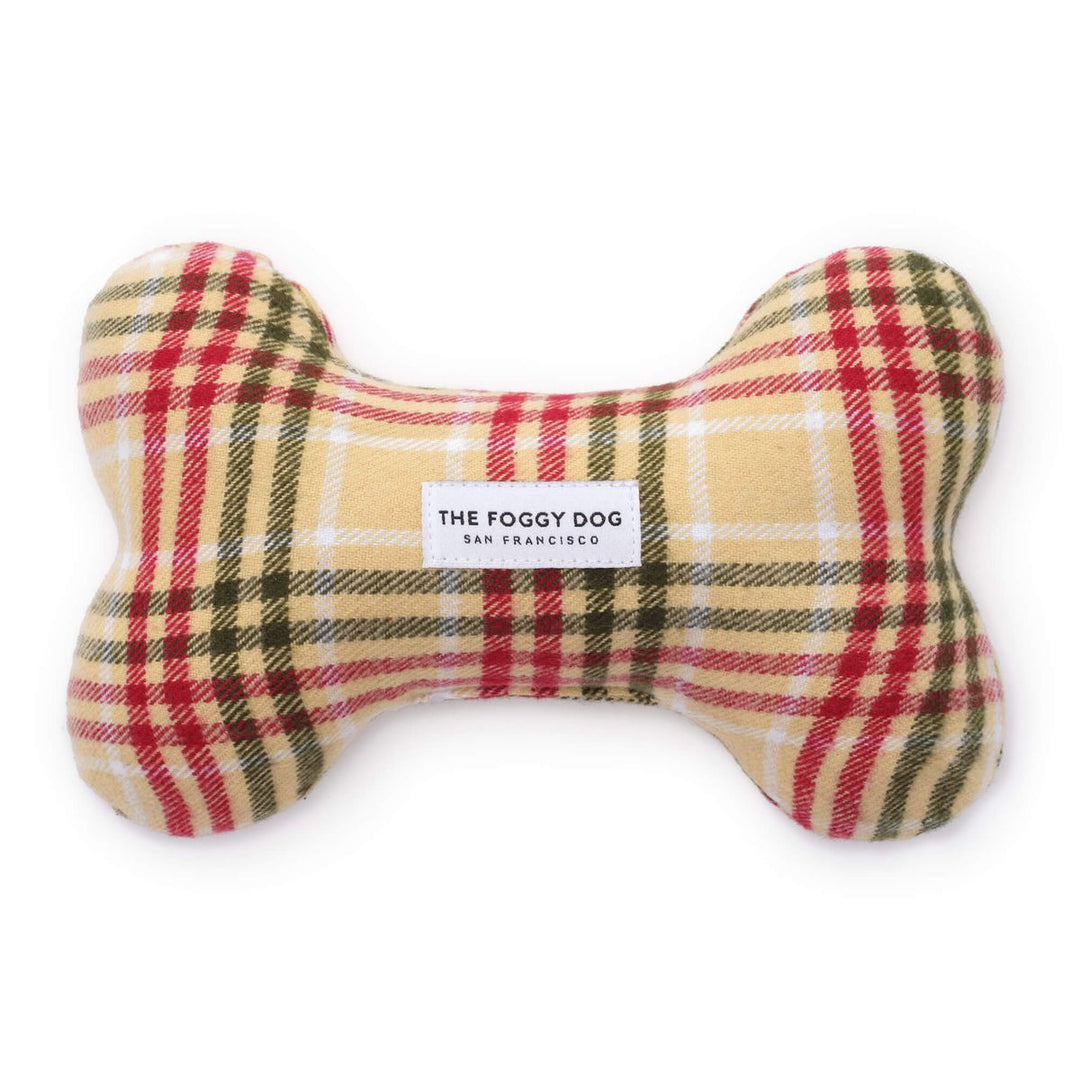 Plaid bone-shaped toy with 'The Foggy Dog' label on a white background