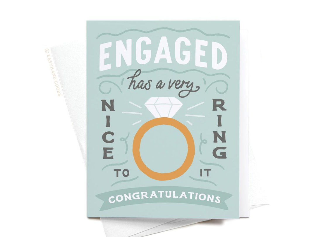 Engaged card with a diamond ring illustration on a light blue background