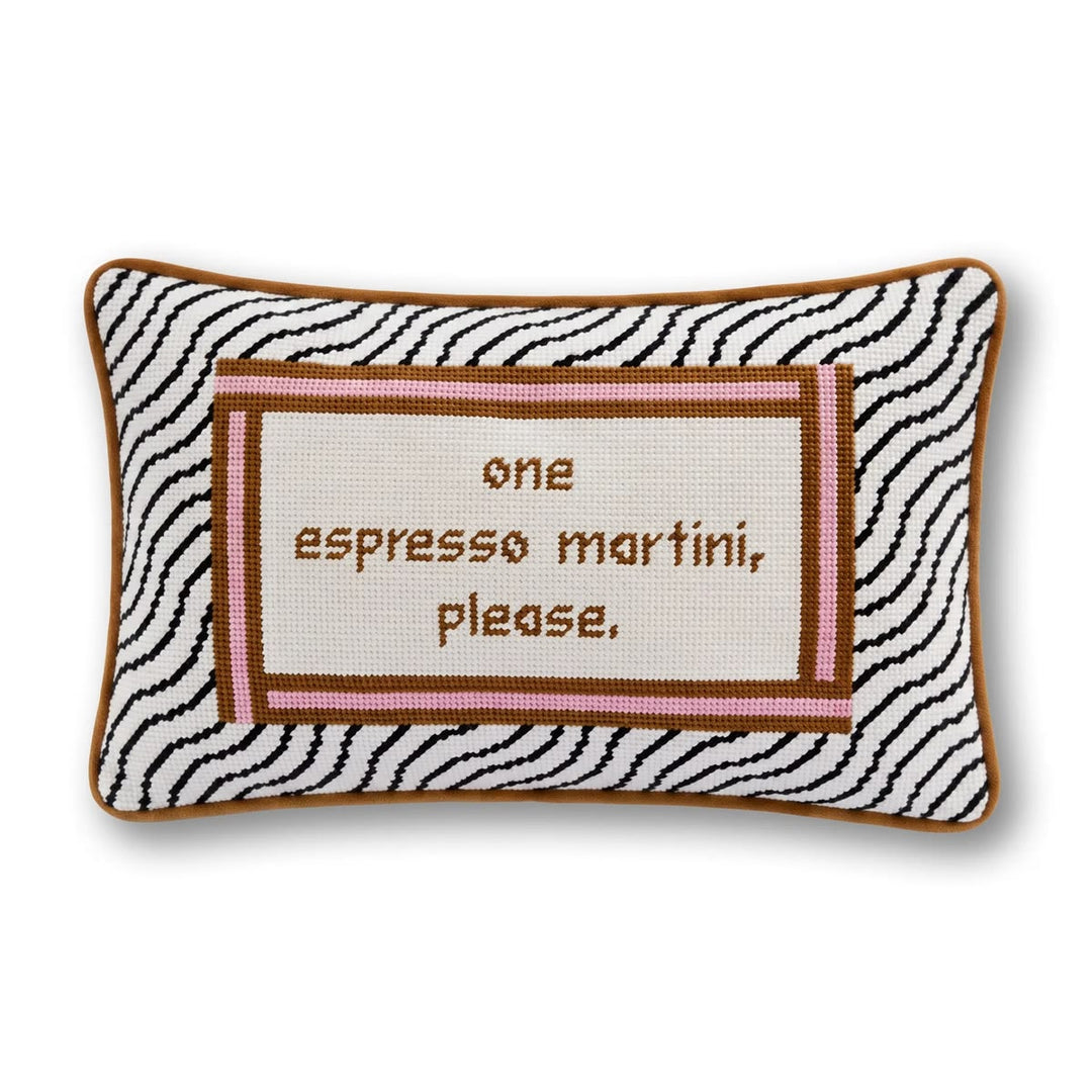 A rectangular decorative throw pillow with a black and white zebra print border, a brown stitched frame, and a central cream panel with brown embroidered text reading 'one espresso martini, please.' on a white background.
