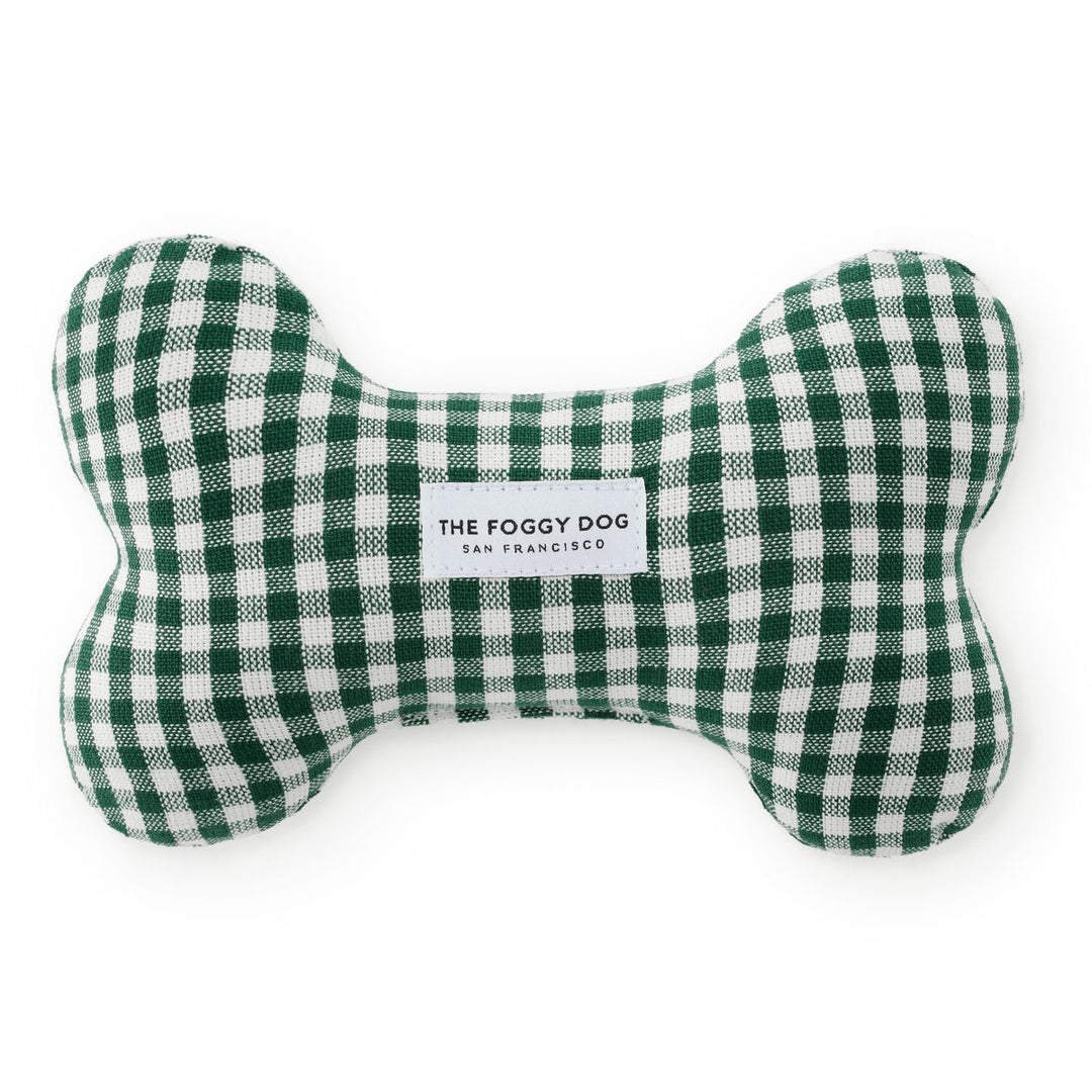 Green and white checkered bone-shaped pet toy with 'The Foggy Dog' branding on a white background
