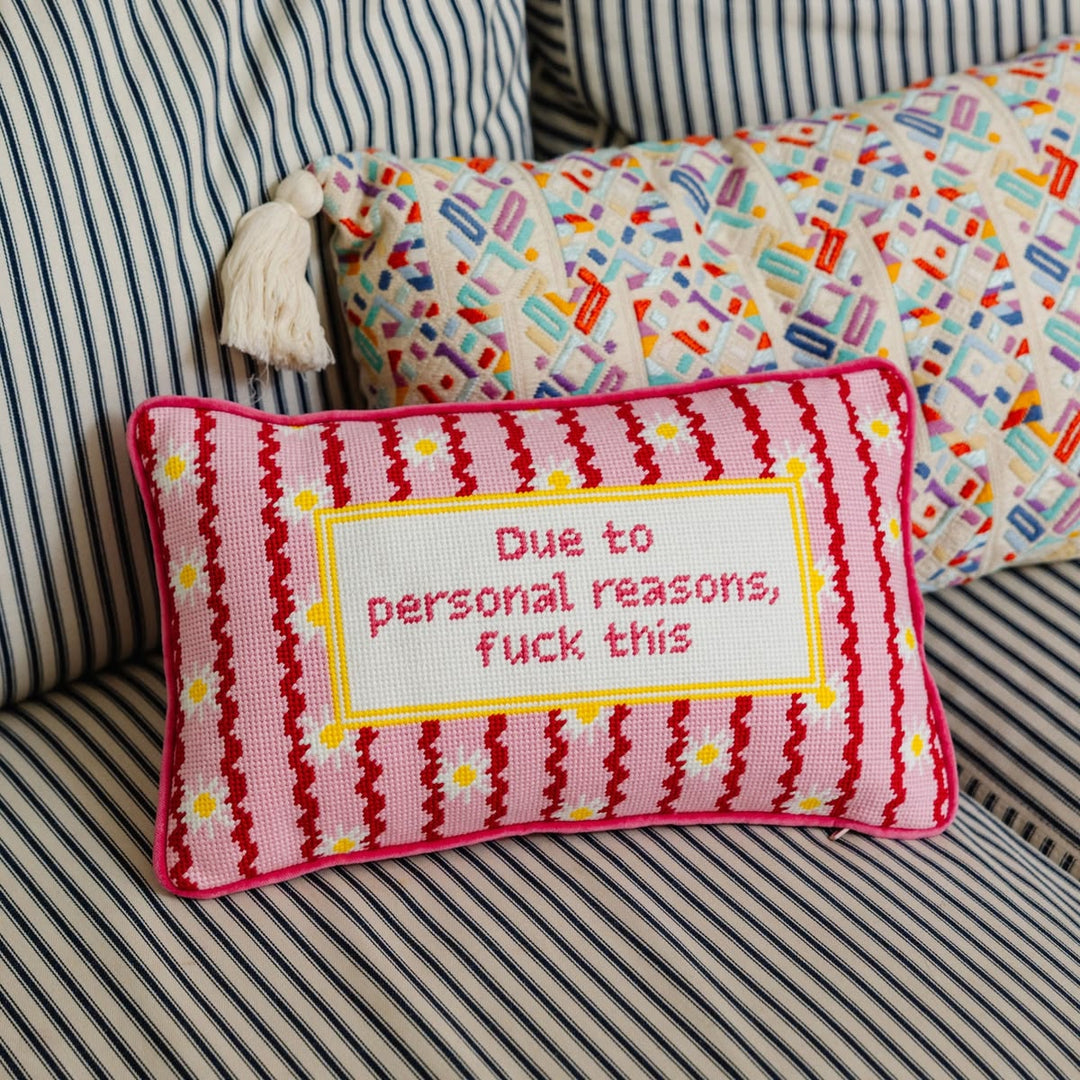Decorative pillow with text on a striped couch