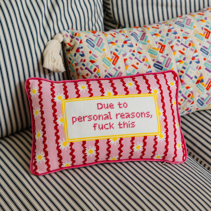Decorative pillow with text on a striped couch