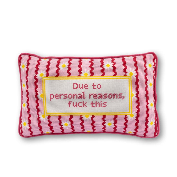 Pink striped pillow with text on a white background