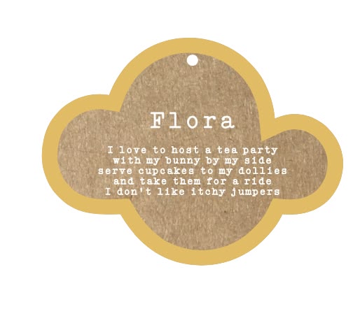 A cloud-shaped decorative tag or label with a kraft brown center and a mustard-gold border, printed with the name 'Flora' and a playful text quote on a white background.