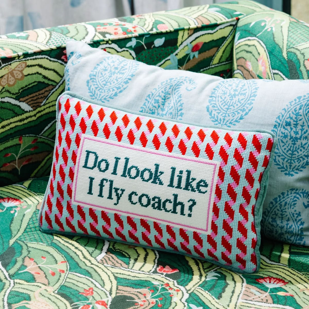 Decorative pillow with text on a patterned couch