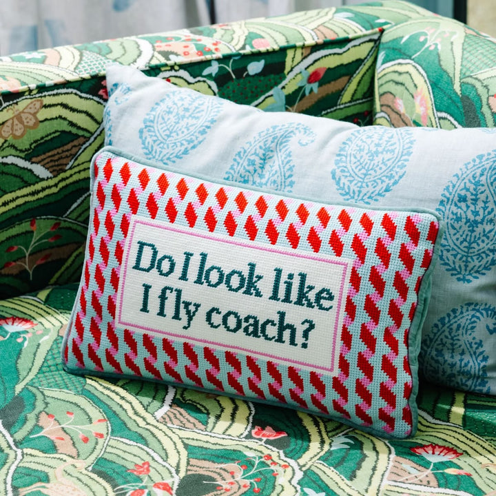 Decorative pillow with text on a patterned couch