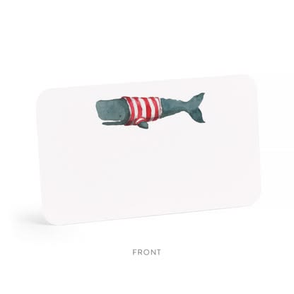 A white rectangular card or book cover shown from the front on a light gray background, featuring a watercolor illustration of a dark teal whale wearing a red-and-white striped shirt. The word FRONT appears below the item.
