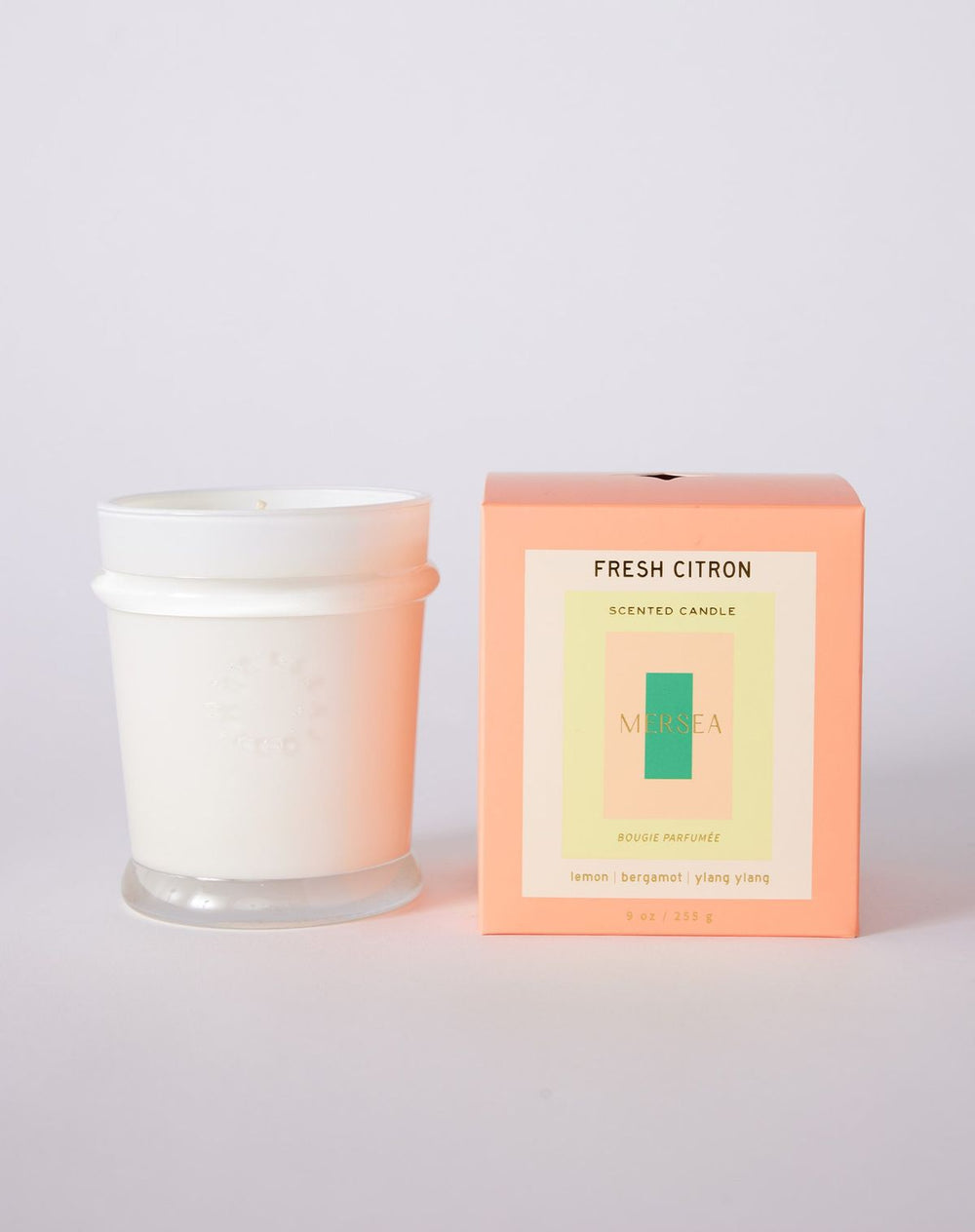 Scented candle with packaging labeled 'Fresh Citron' on a light gray background