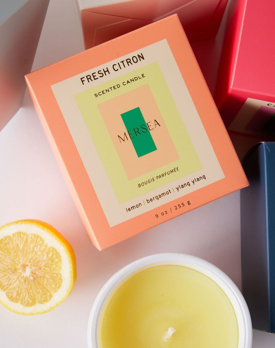 Marsea Fresh Citron scented candle with packaging and a lemon wedge on a light background