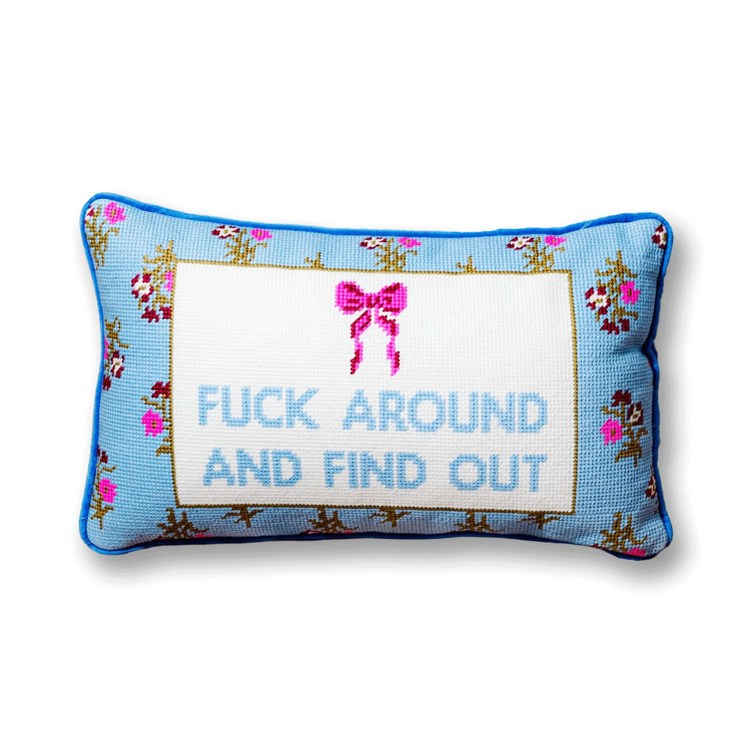 Decorative pillow with floral border and text on a white background