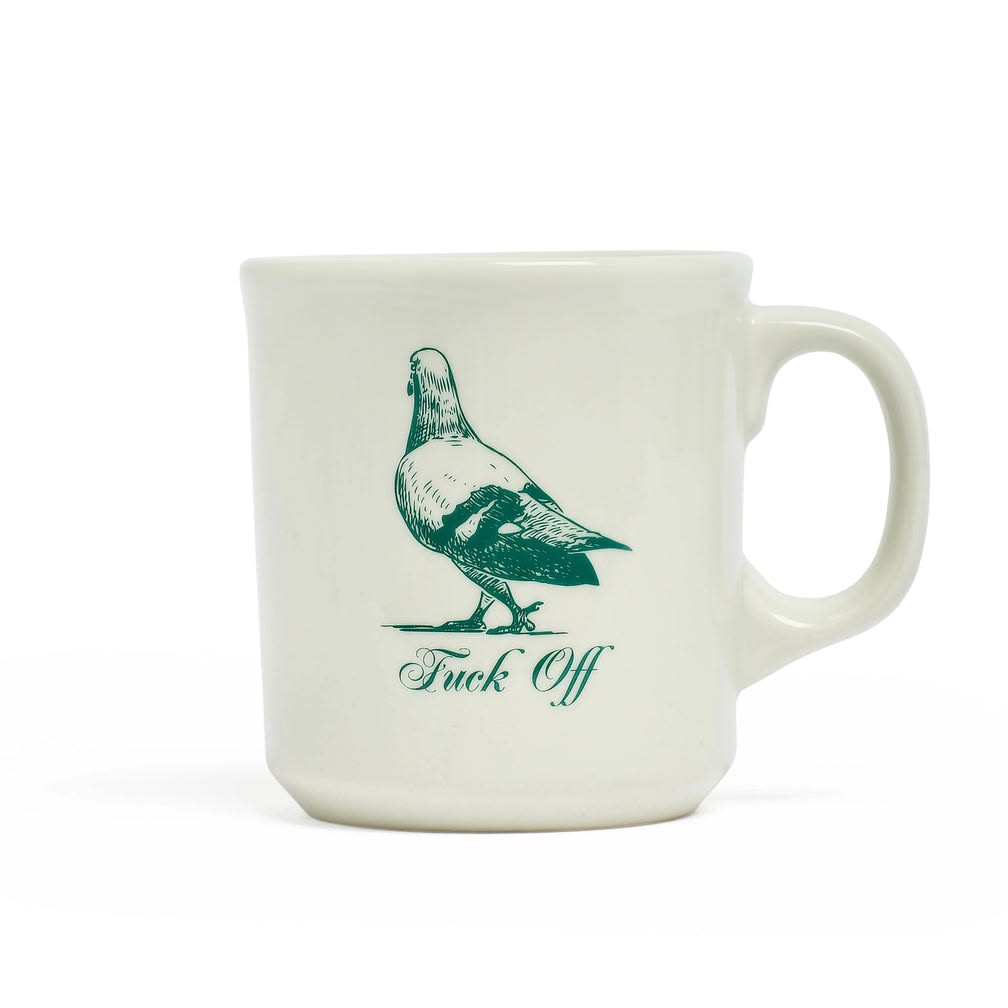 White mug with green bird illustration and text on a white background