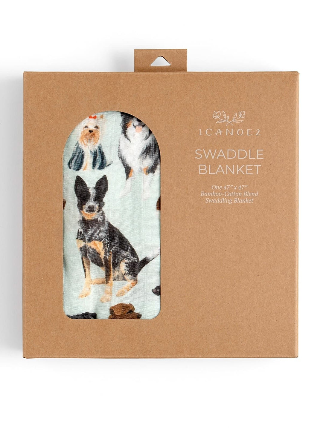 A packaged swaddle blanket in a brown kraft paper box. The package has a die-cut window showing a light blue cotton swaddle blanket printed with images of dogs, including a black and tan Australian Cattle Dog.