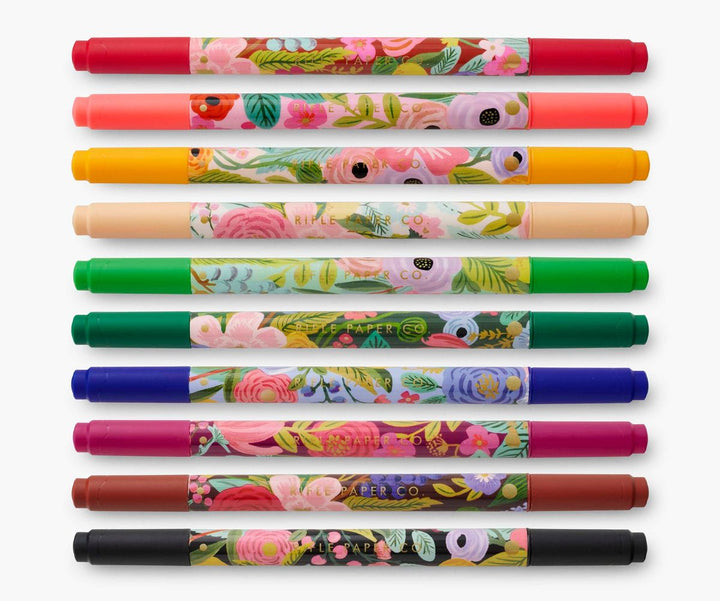 Set of colorful markers with floral designs on a white background