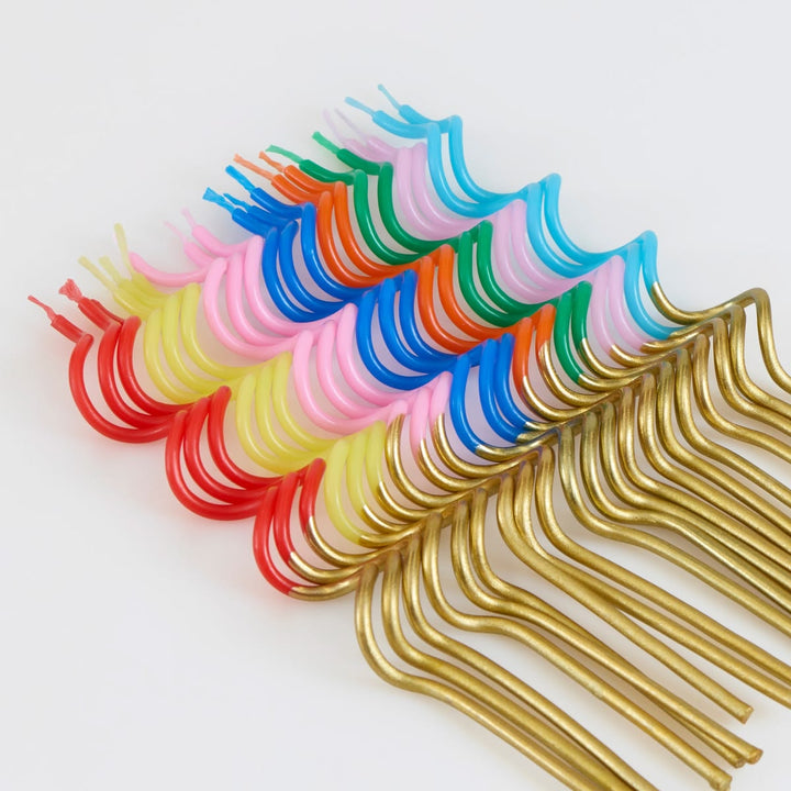 Colorful metal hooks arranged in a row on a white background