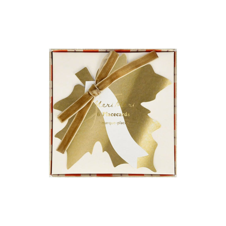 Packaged gold placecards with a bow on a white background