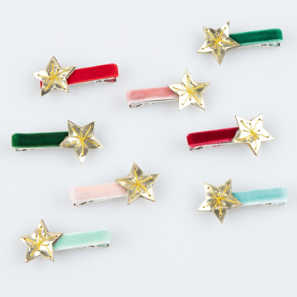 Star-shaped hair clips with colorful bars on a white background