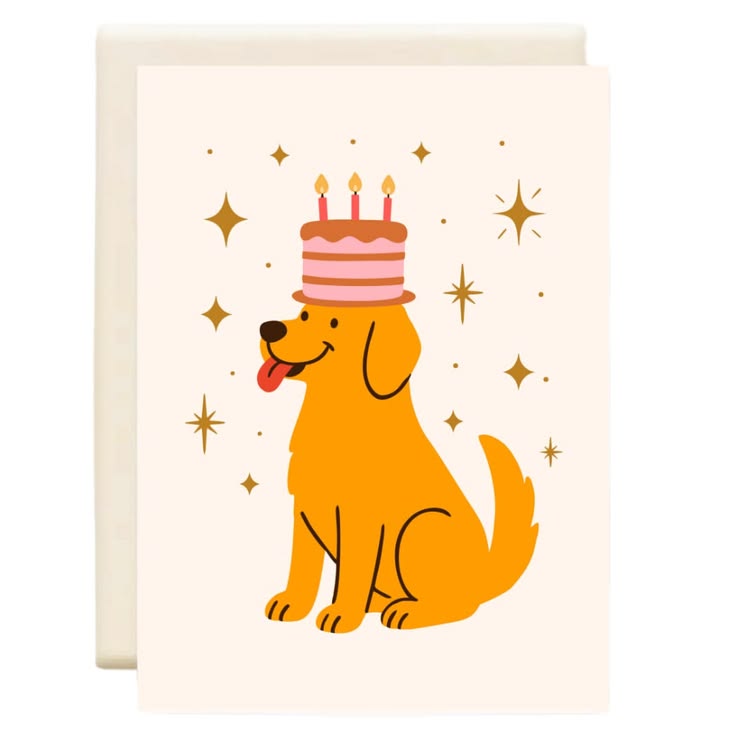 A square greeting card with a cream-colored background featuring a cartoon golden retriever wearing a pink and brown birthday cake on its head, surrounded by gold starbursts. A second cream card is partially visible behind it.