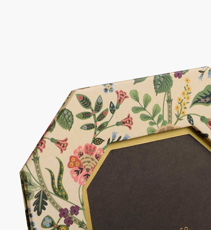 Hexagonal photo frame with floral design on a white background