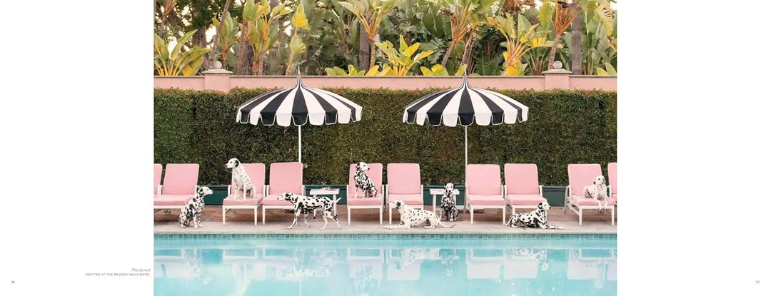 A square art print featuring a luxurious poolside scene with pink lounge chairs, two black and white striped umbrellas, and Dalmatian dogs lounging by the water, set against a green hedge and tropical foliage.