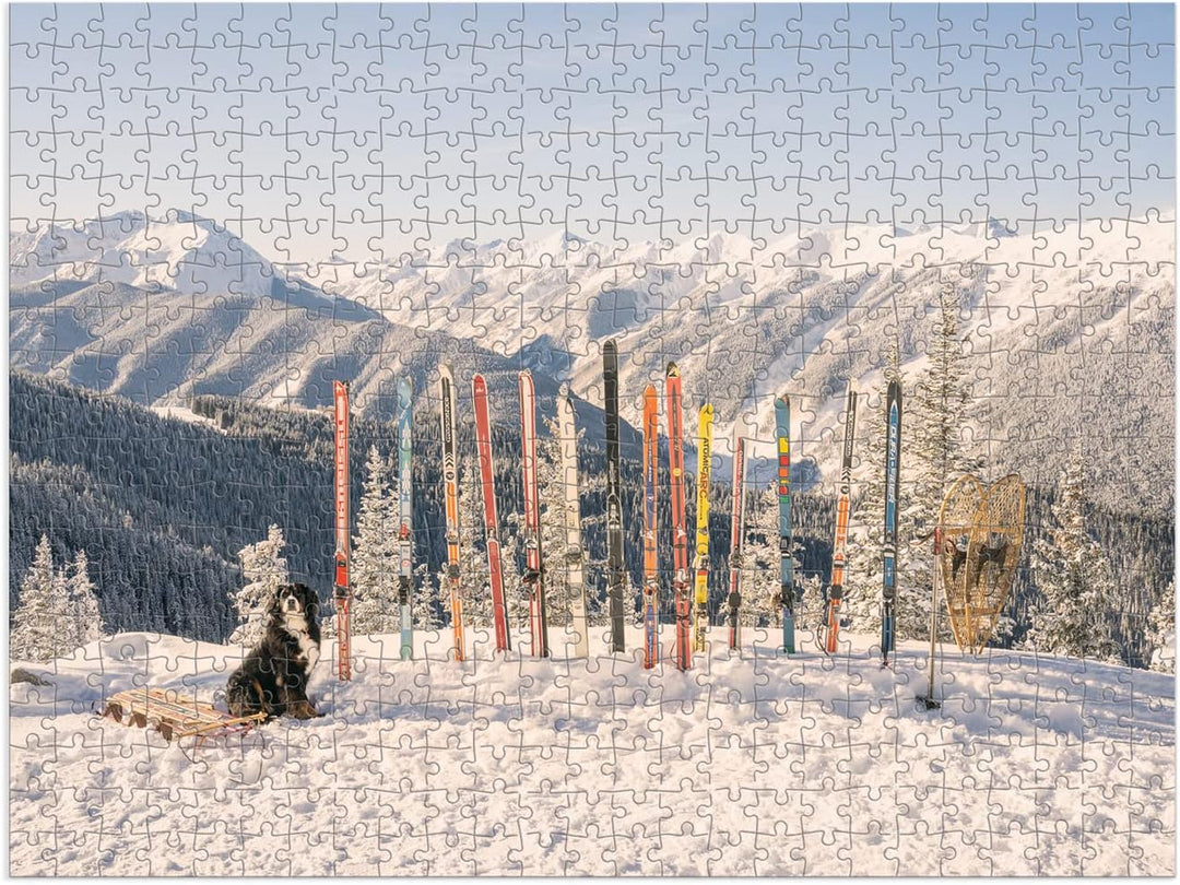 Jigsaw puzzle with a winter scene featuring a dog, skis, and snow-covered mountains.