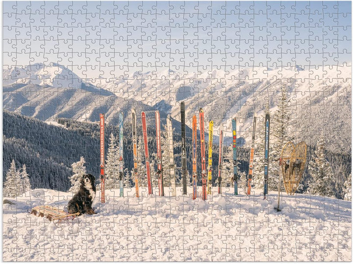 Jigsaw puzzle with a winter scene featuring a dog, skis, and snow-covered mountains.