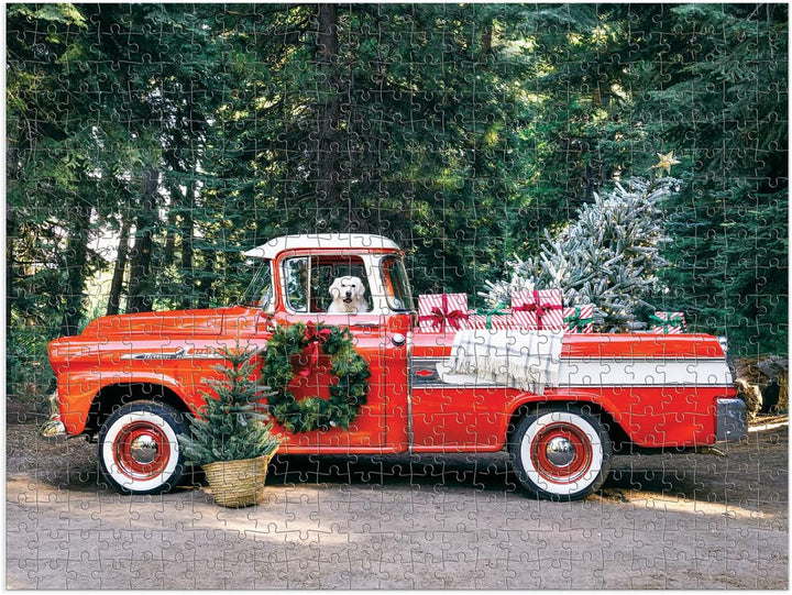 Jigsaw puzzle with a red truck, dog, and Christmas tree in a forest setting