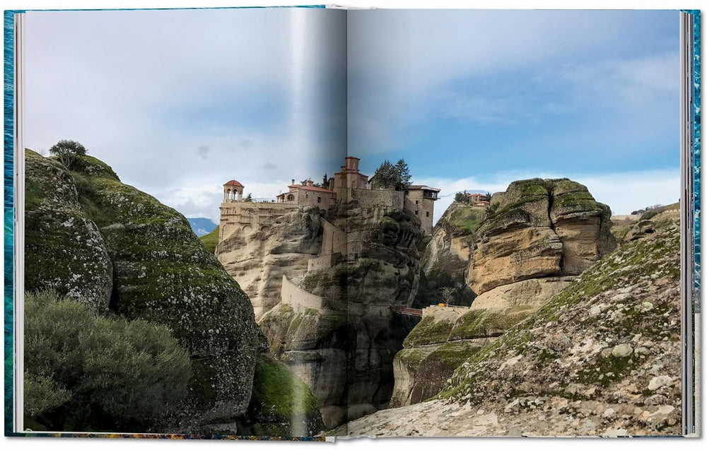 Stalactite-like rock formations with a building perched on top against a blue sky.