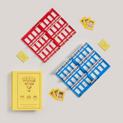 Guess Who? game components including cards and trays on a gray background