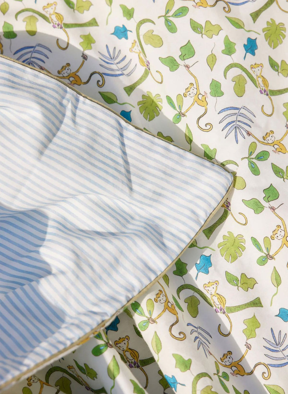 Baby blanket with blue stripes and colorful monkey pattern