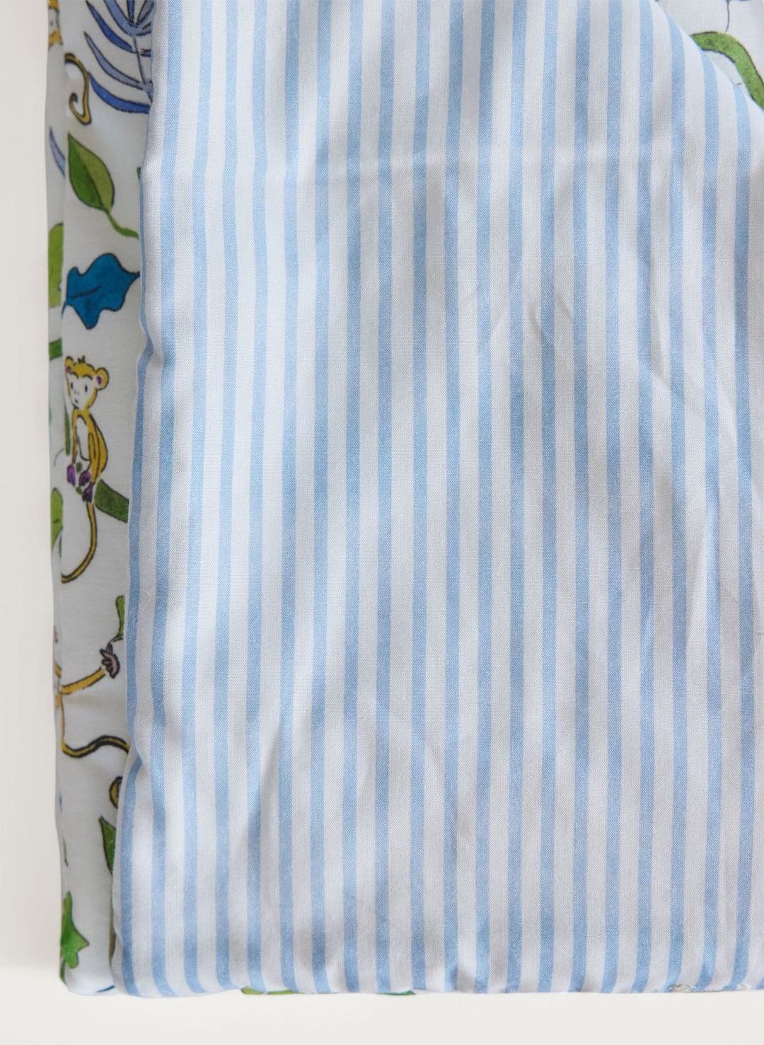 Striped fabric with blue and white stripes on a patterned background