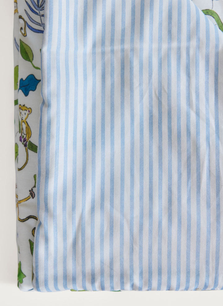 Striped fabric with blue and white stripes on a patterned background