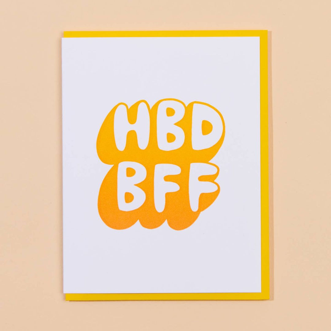 Framed artwork with 'HBD BFF' text on a beige background