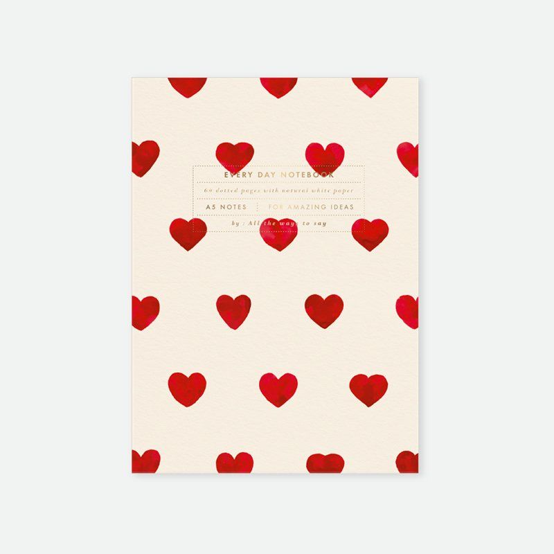 Notebook with red heart pattern on a beige background