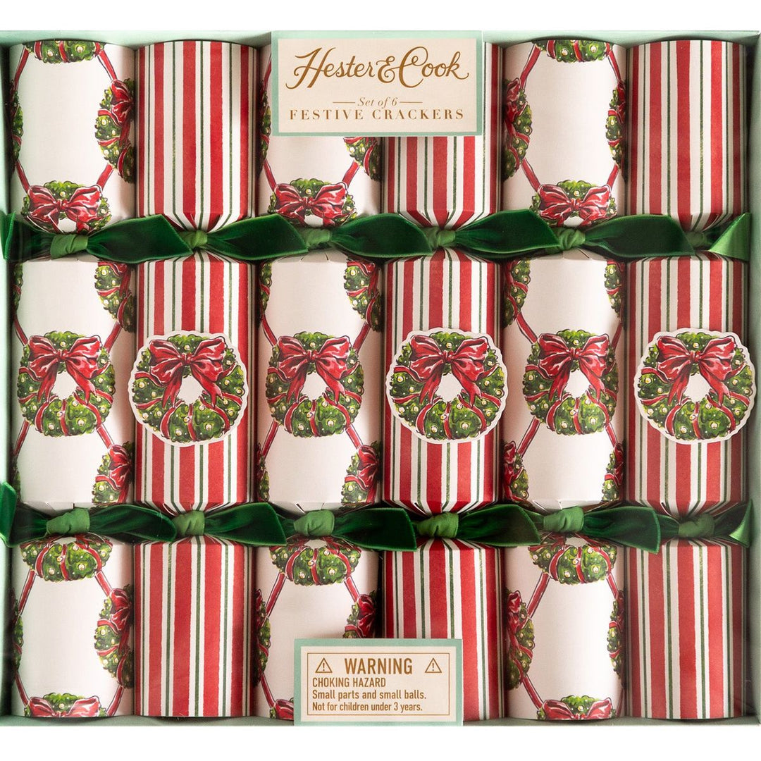 Box of Hester & Cook festive crackers with red and green ribbons.