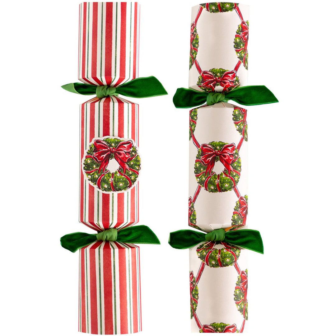 Two Christmas crackers with festive designs on a white background