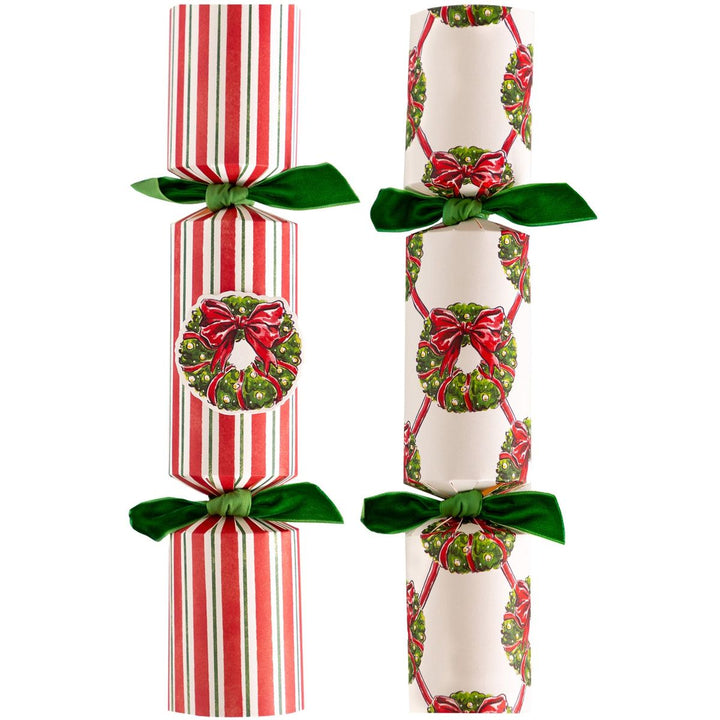 Two Christmas crackers with festive designs on a white background