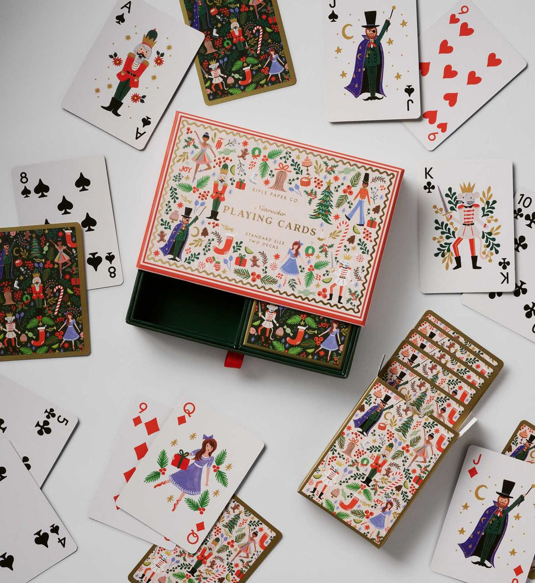 Set of playing cards with decorative box on a white background