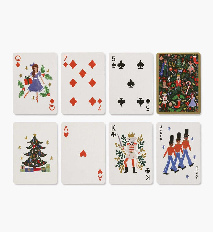 Set of playing cards with festive designs on a white background