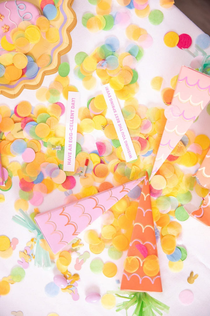 Colorful party decorations with streamers and confetti on a white background