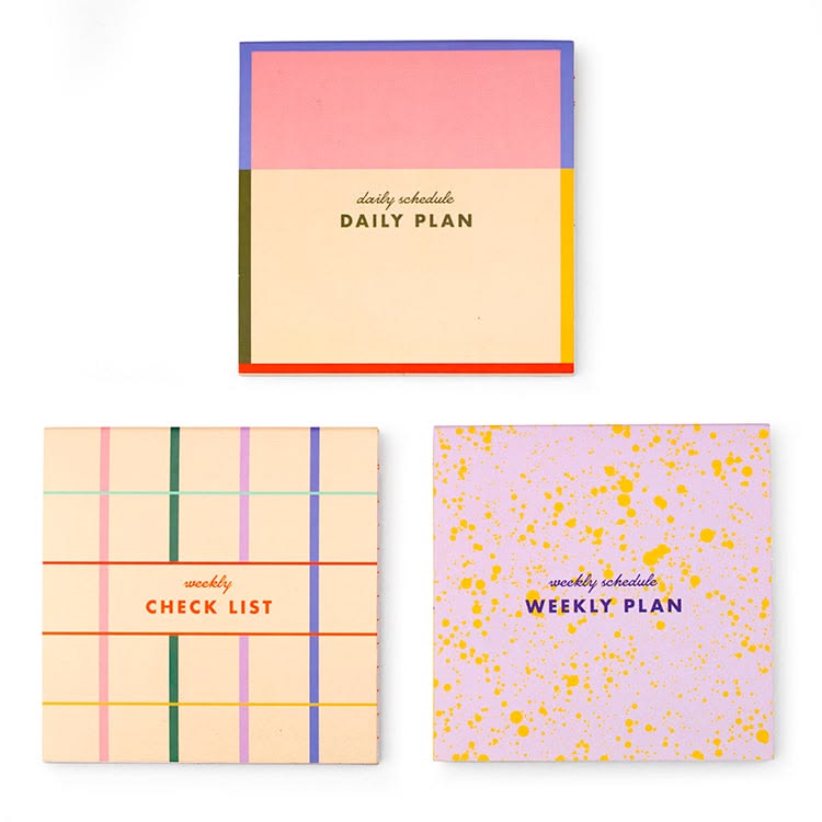 Three colorful planners with different designs and text on a white background