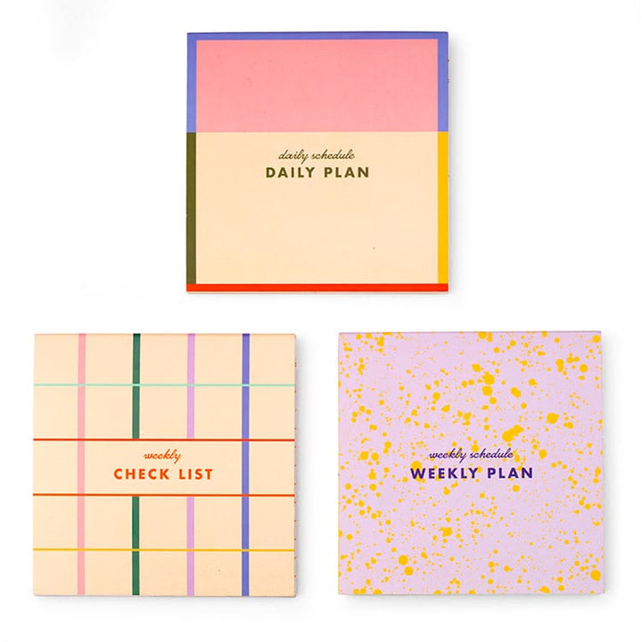 Three colorful planners with different designs and text on a white background