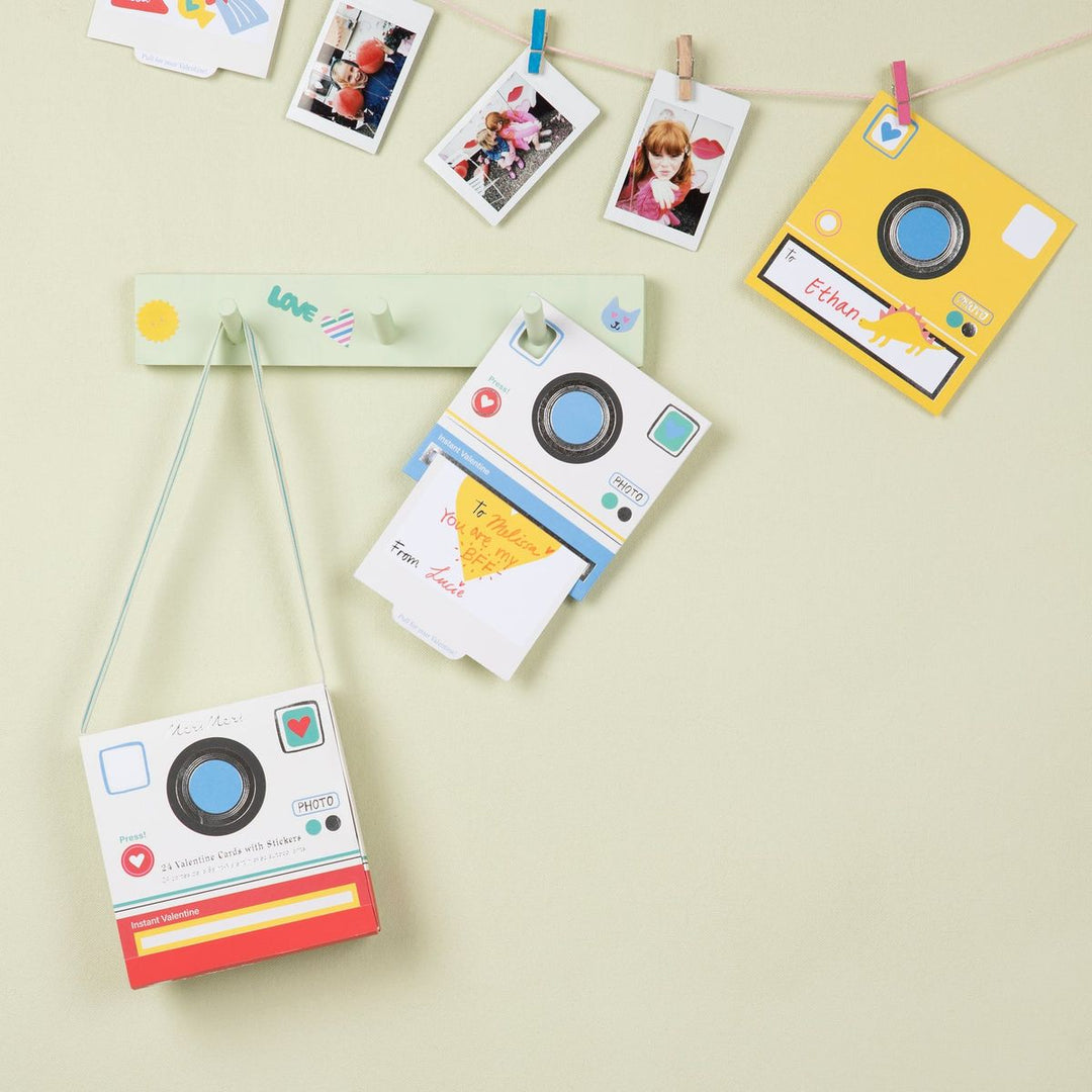 Colorful camera-shaped photo frames on a light background