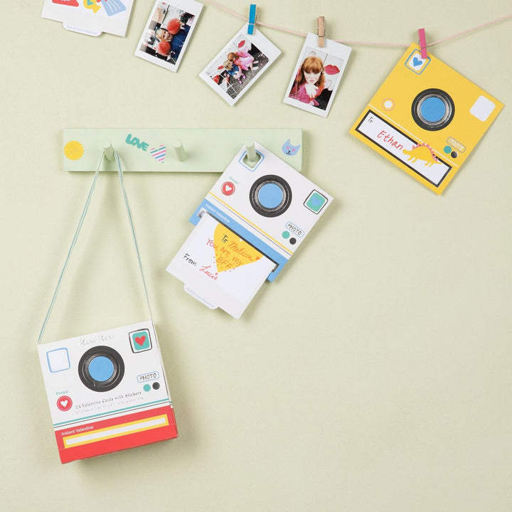 Colorful camera-shaped photo frames on a light background