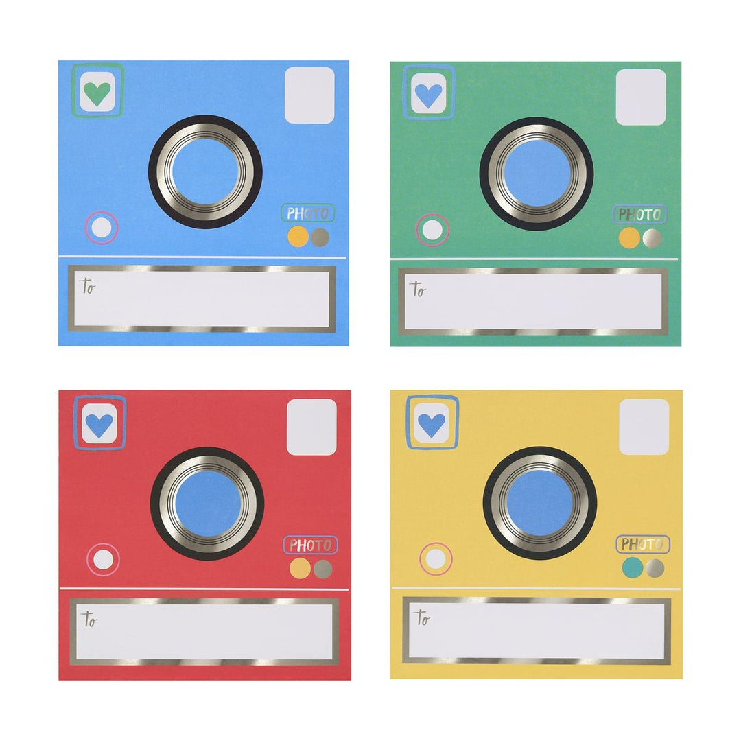 Four colorful photo album covers in blue, green, red, and yellow on a white background.