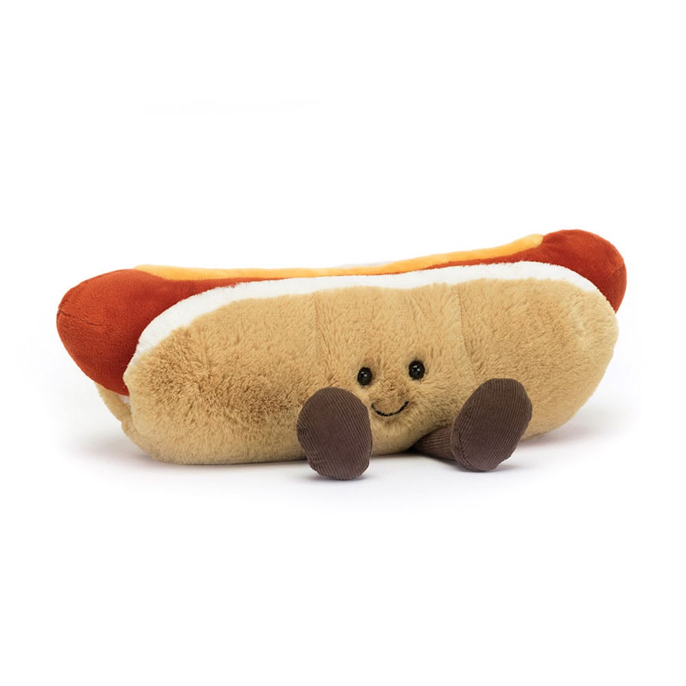 Plush toy hot dog with a smiling face on a white background