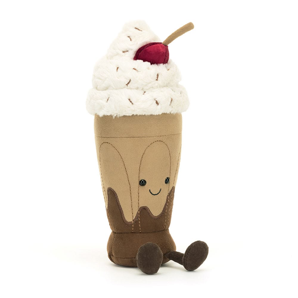 Toy resembling a chocolate milkshake with whipped cream and a cherry on top against a white background