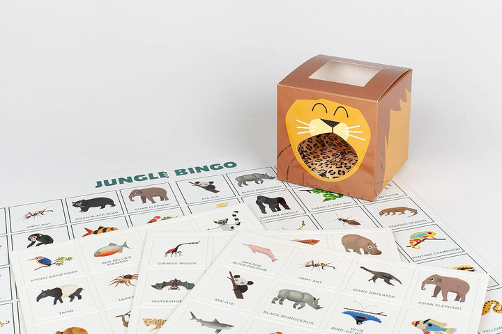 A children's animal identification game set with printed cards labeled 'JUNGLE BINGO' and a small lion-face box used as a bingo call box, photographed on a clean white studio background.